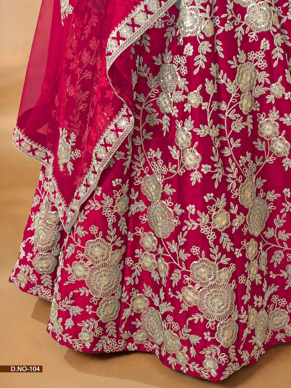 Close-up of thread and sequence embroidery work on red art silk lehenga fabric
