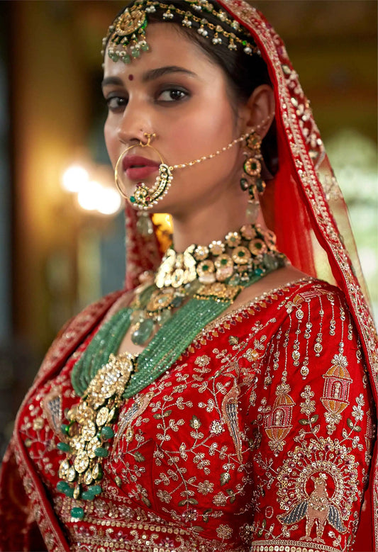 Red Bridal Lehenga Featuring Rich Embroidery & Pearl