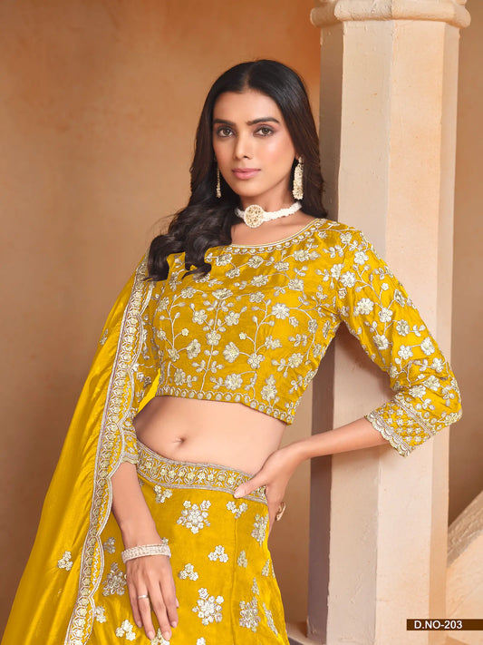 Half view of yellow organza lehenga choli showing embroidered blouse detailing
