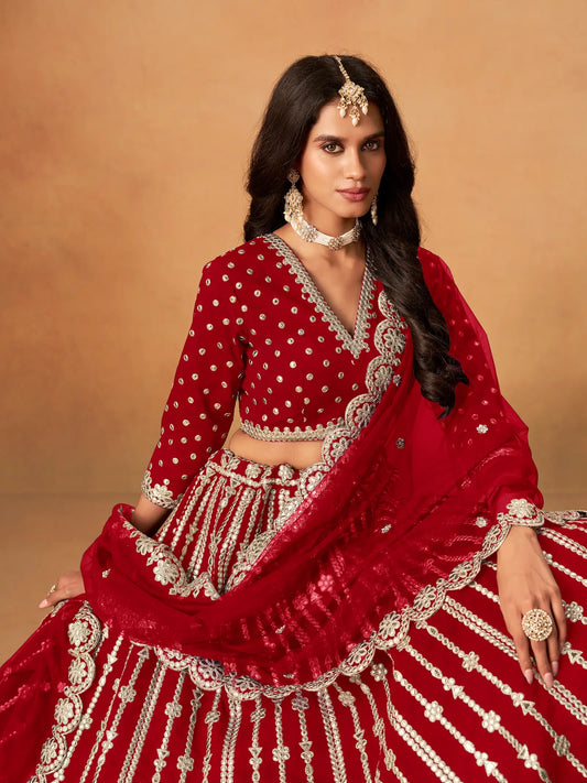 Close-up of red art silk lehenga choli showing paper mirror and embroidery blouse detailing