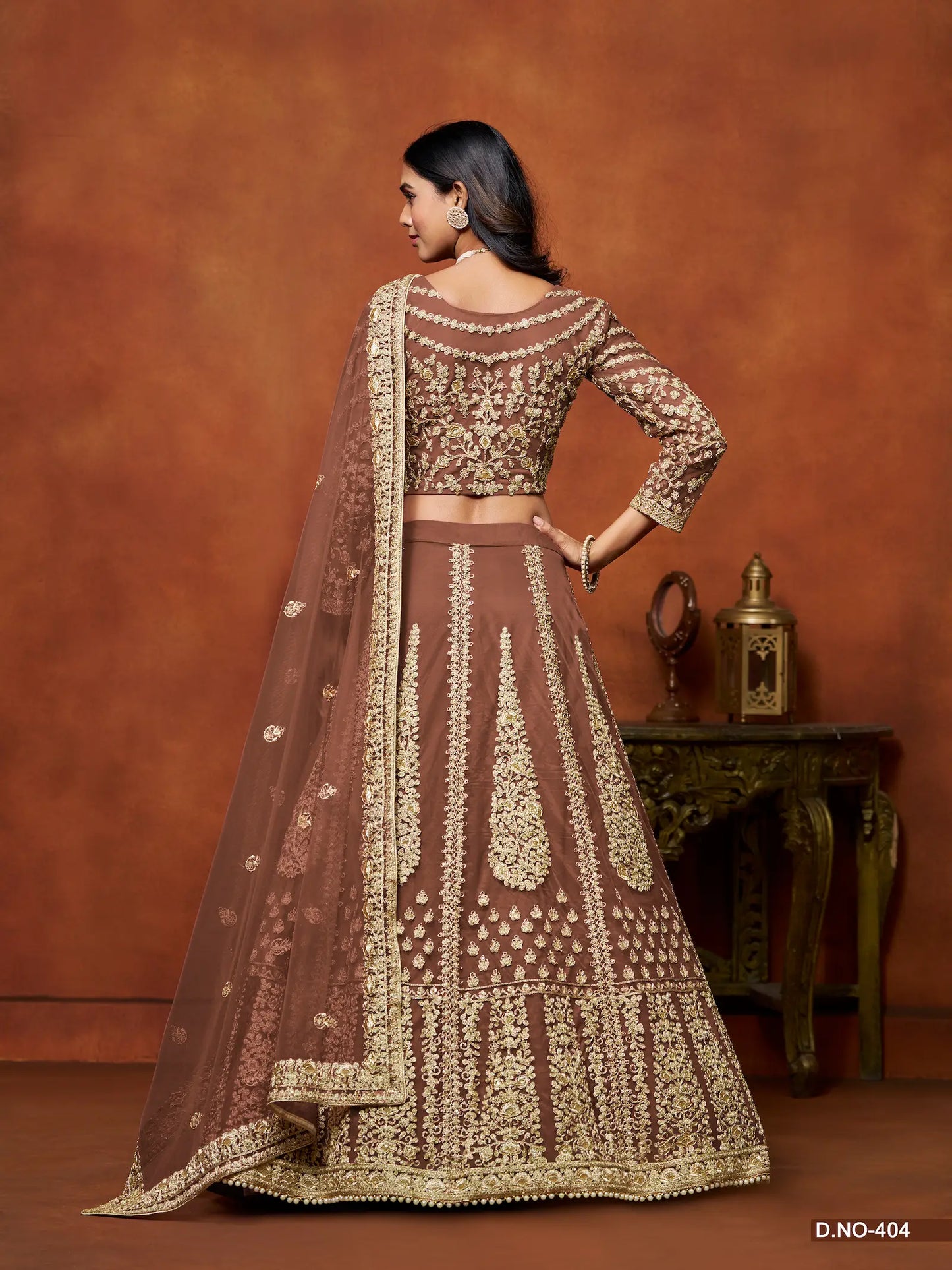 Back view of brown net lehenga choli with dupatta and embroidery detailing