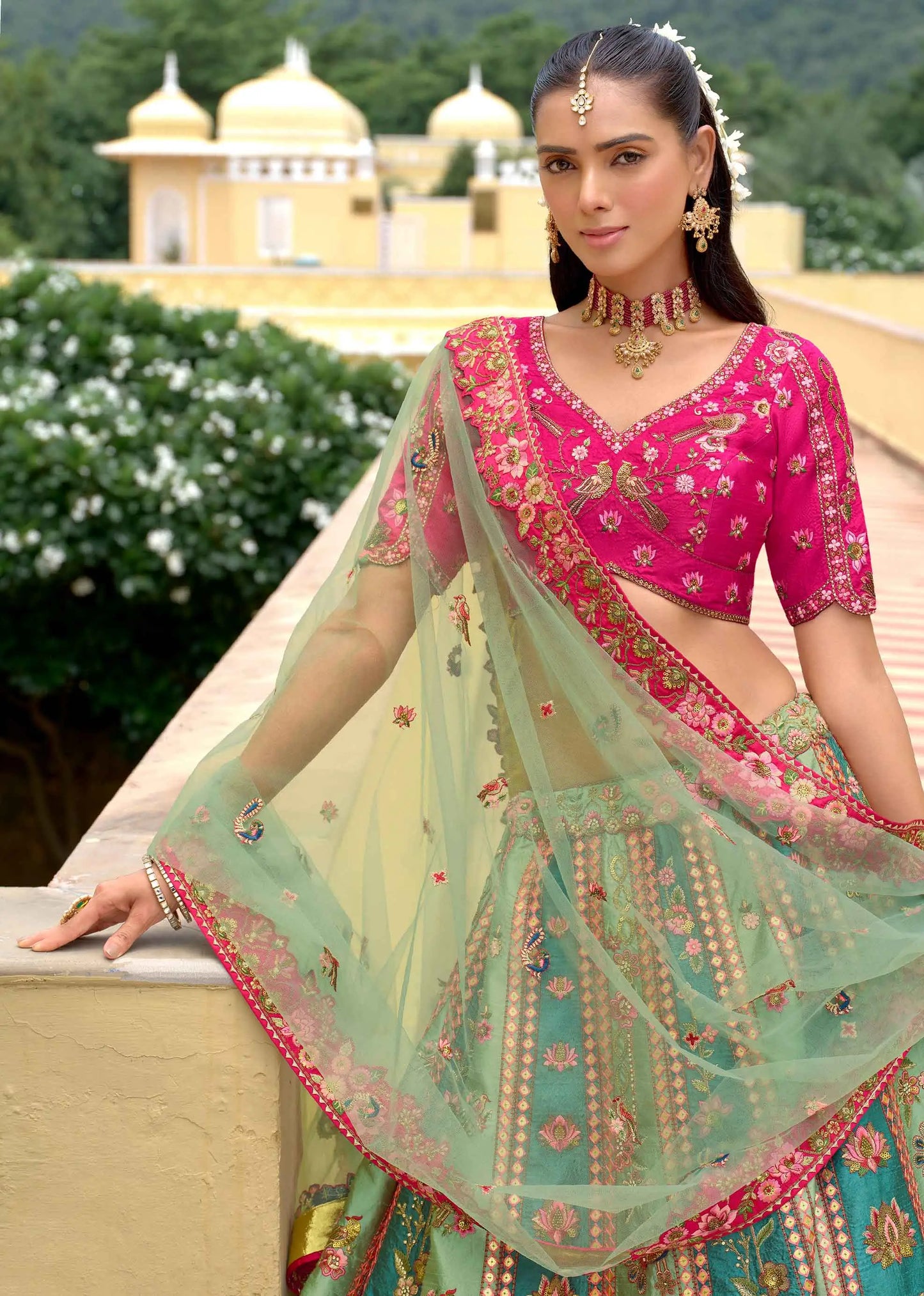 Close-up of pink blue lehenga showing heavy embroidery and sequins detailing