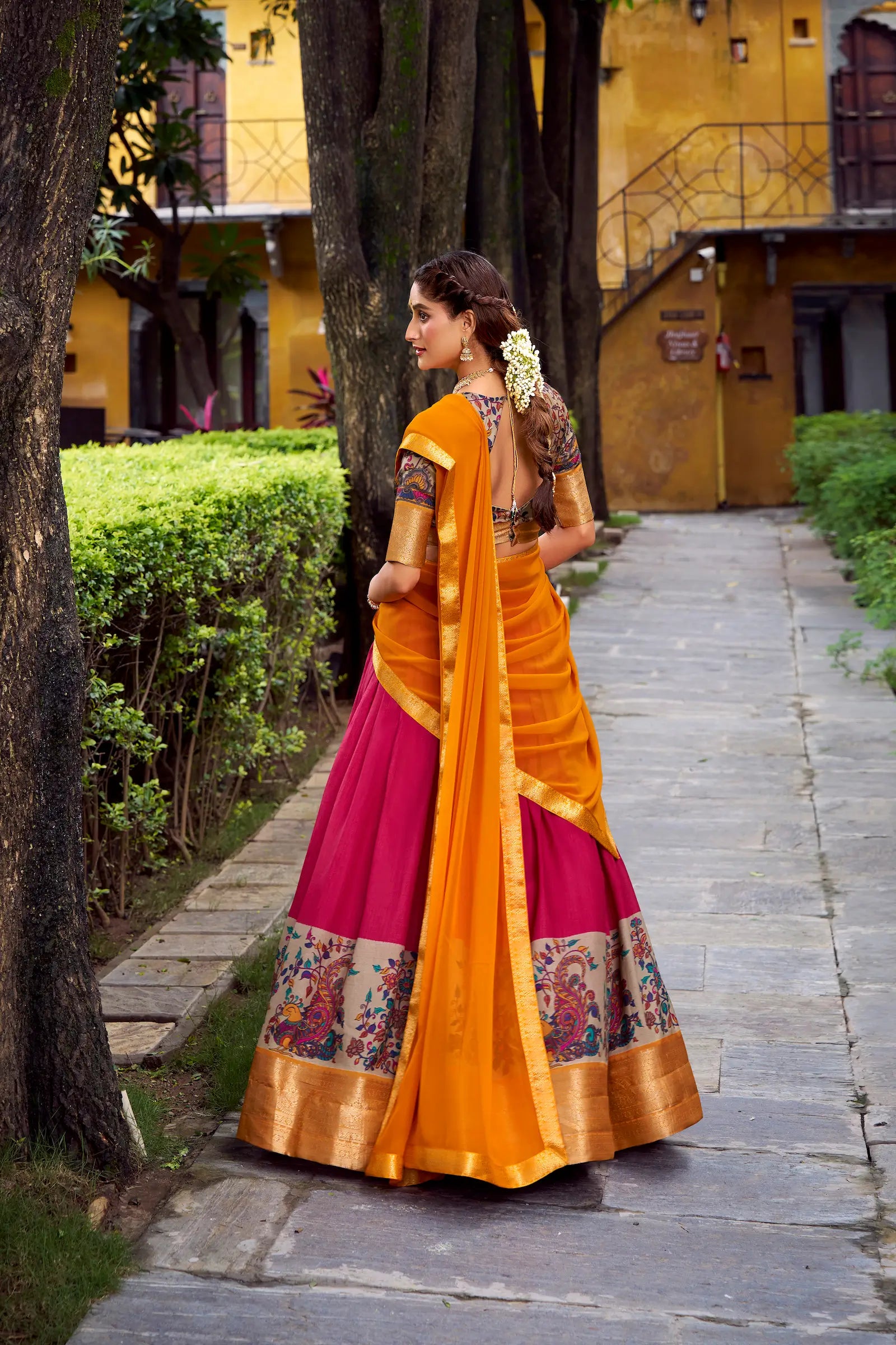 Back view of hot pink printed and zari weaving silk lehenga choli full look