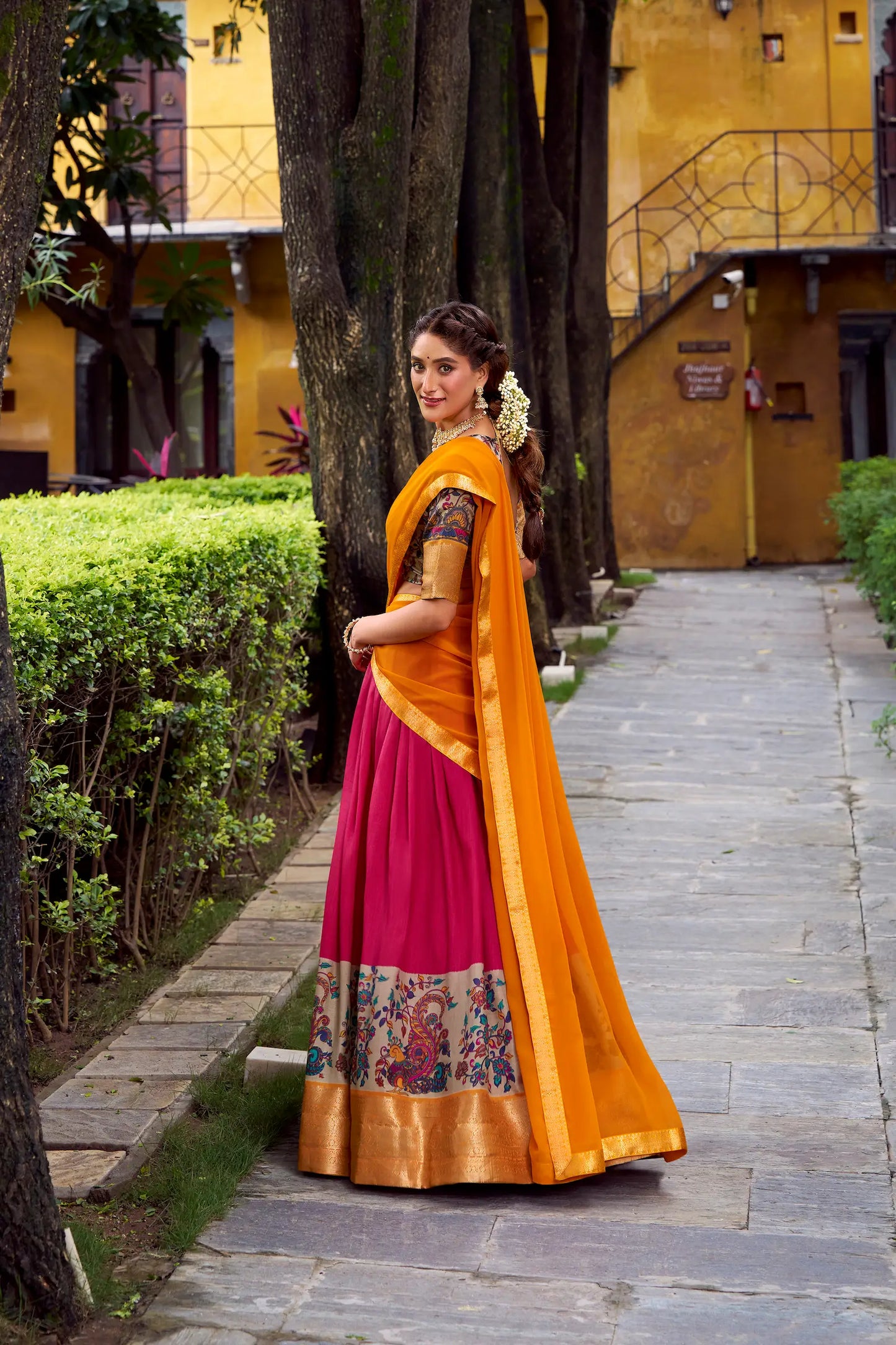 Side view of hot pink printed and zari weaving silk lehenga choli full look