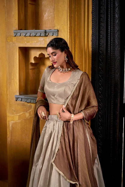 Half view of sand beige dhupian silk lehenga choli showing zari weaving work