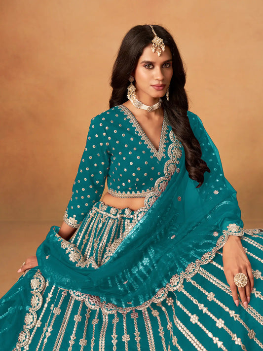 Close-up of teal blue art silk lehenga choli showing paper mirror and embroidery blouse detailing