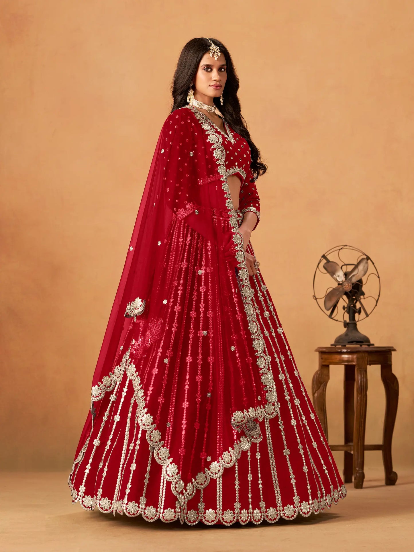 Side view of red art silk paper mirror and embroidery lehenga choli with dupatta