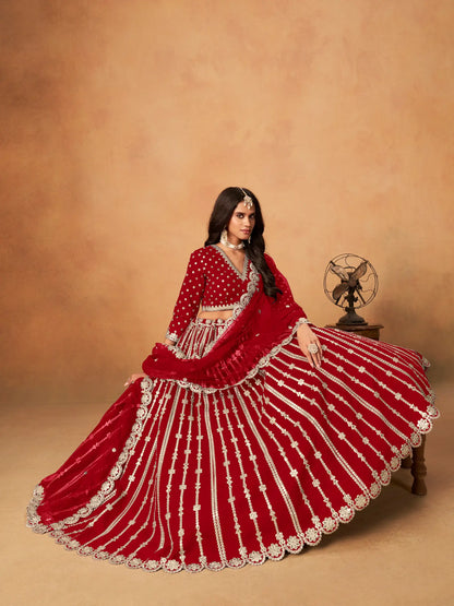 Model sitting wearing red art silk lehenga choli with paper mirror and embroidery work