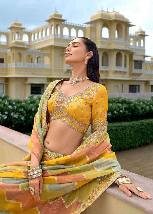 Close-up of pastel yellow lehenga showing detailed designer embroidery work