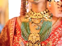 Red Bridal Lehenga Featuring Rich Embroidery & Pearl