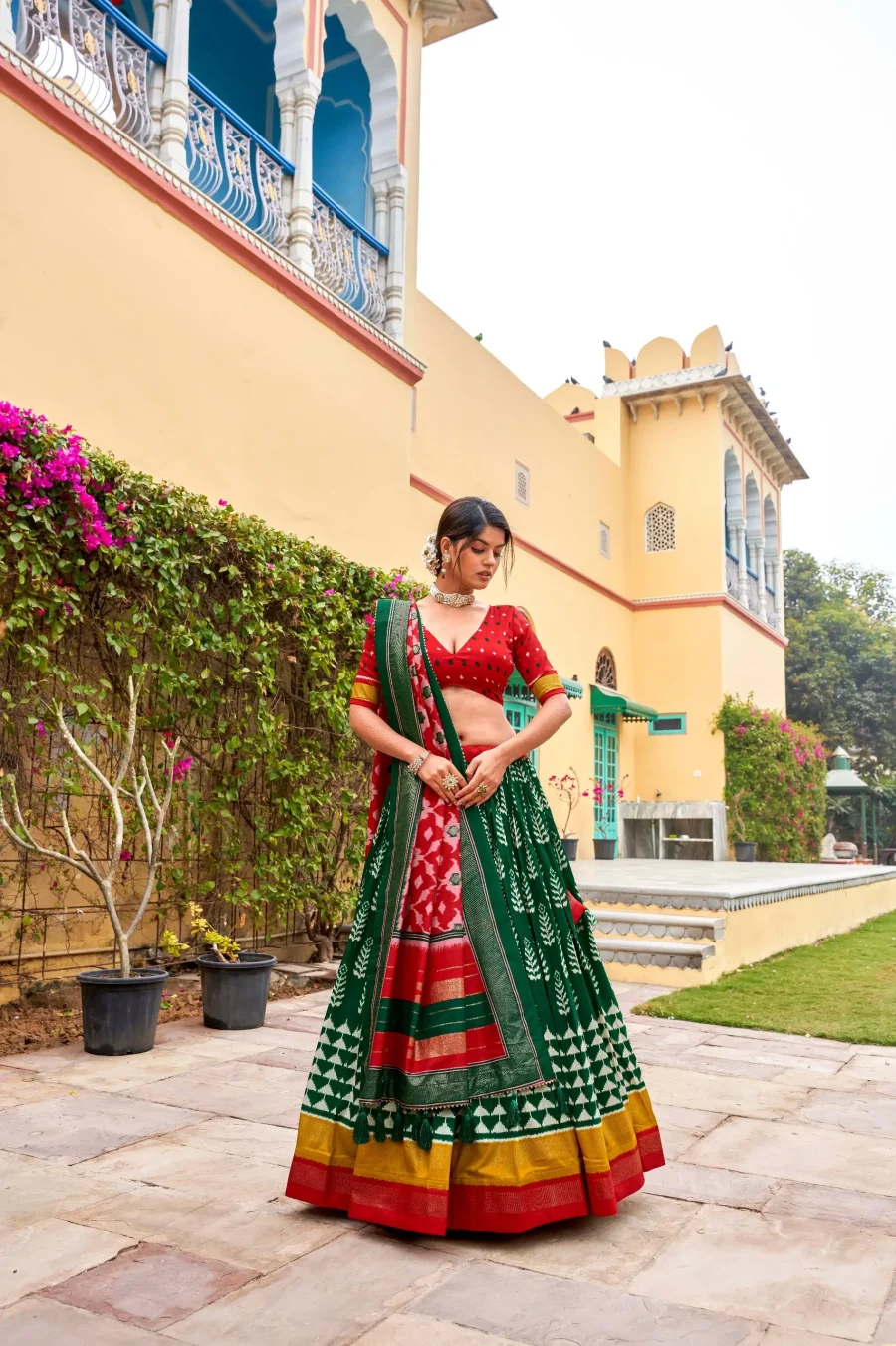 Fabulous blend of Pine Green and Persian Red silk Patola lehenga choli