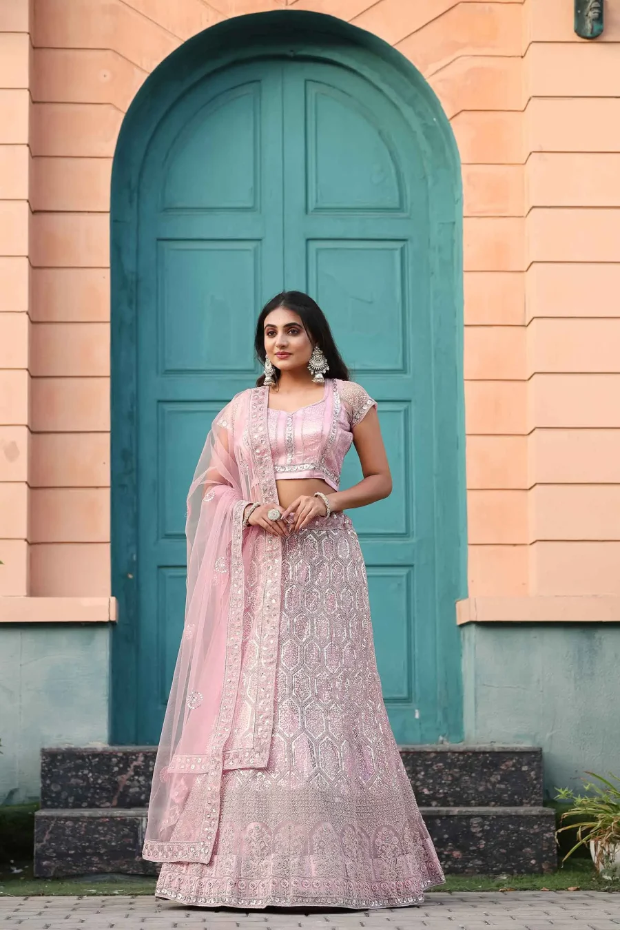 customarily Pink Embellished With Beautiful Embroidery worked net lehenga choli